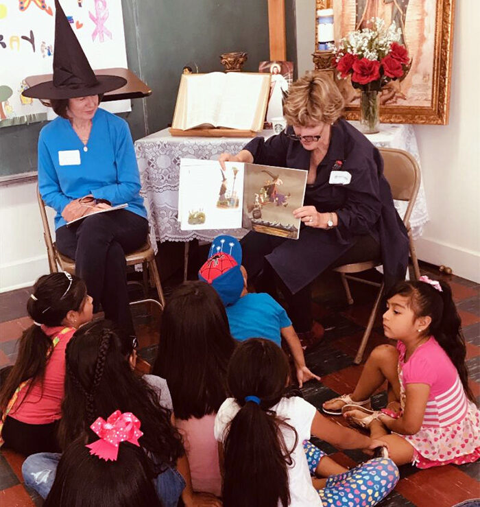 Christ Child Society of Pasadena volunteers read to school children at Halloween as part of their United in Service event