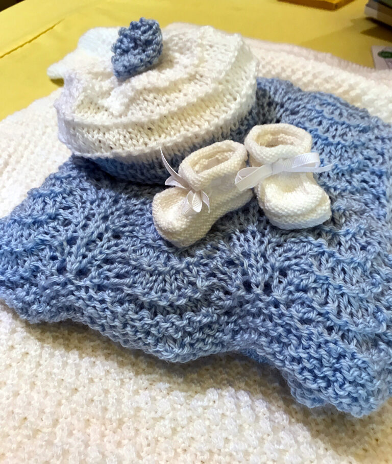 Beautiful blanket, hat and booties made for layette from the Christ Child Society of Pasadena